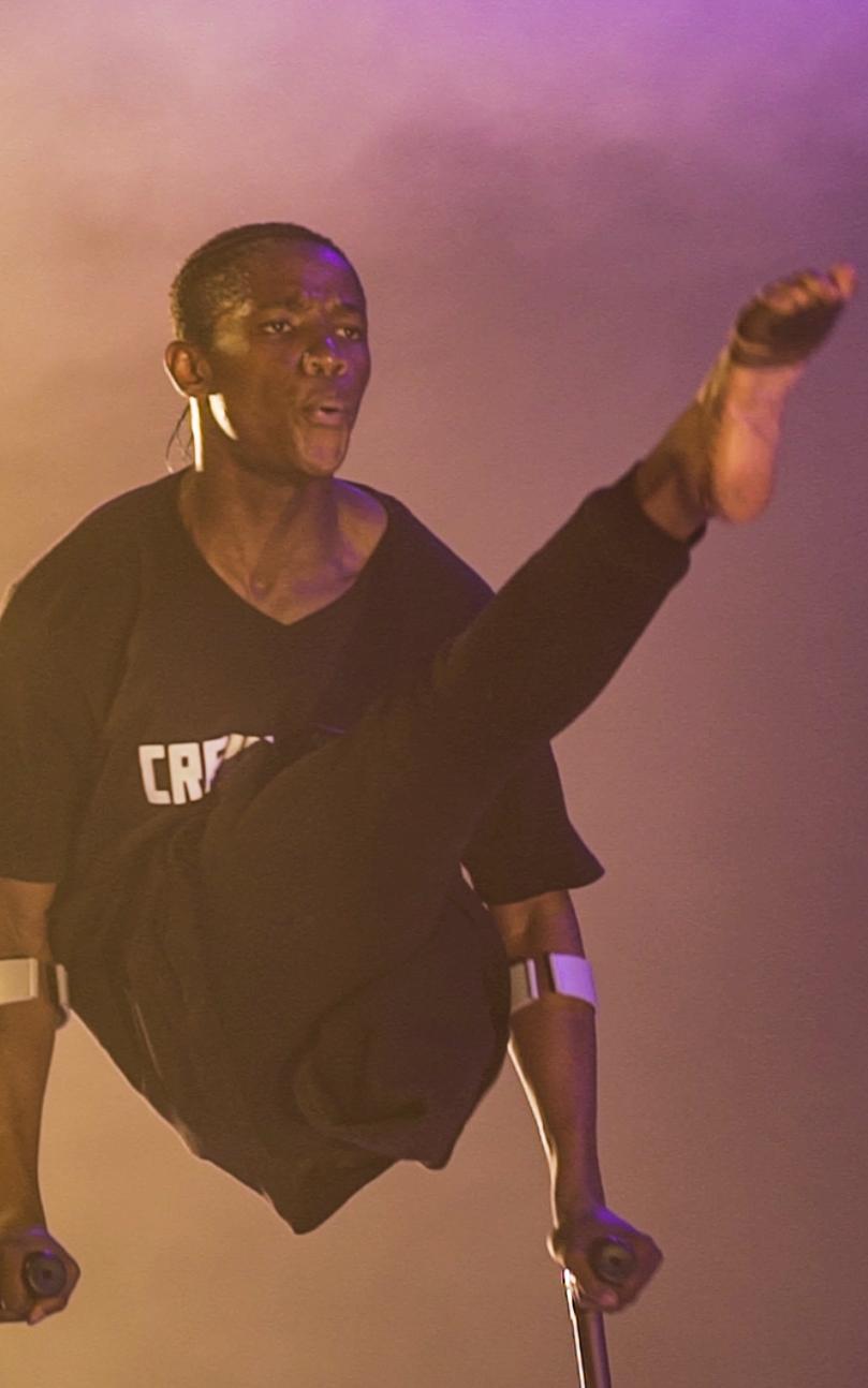 Black performer on crutches on stage