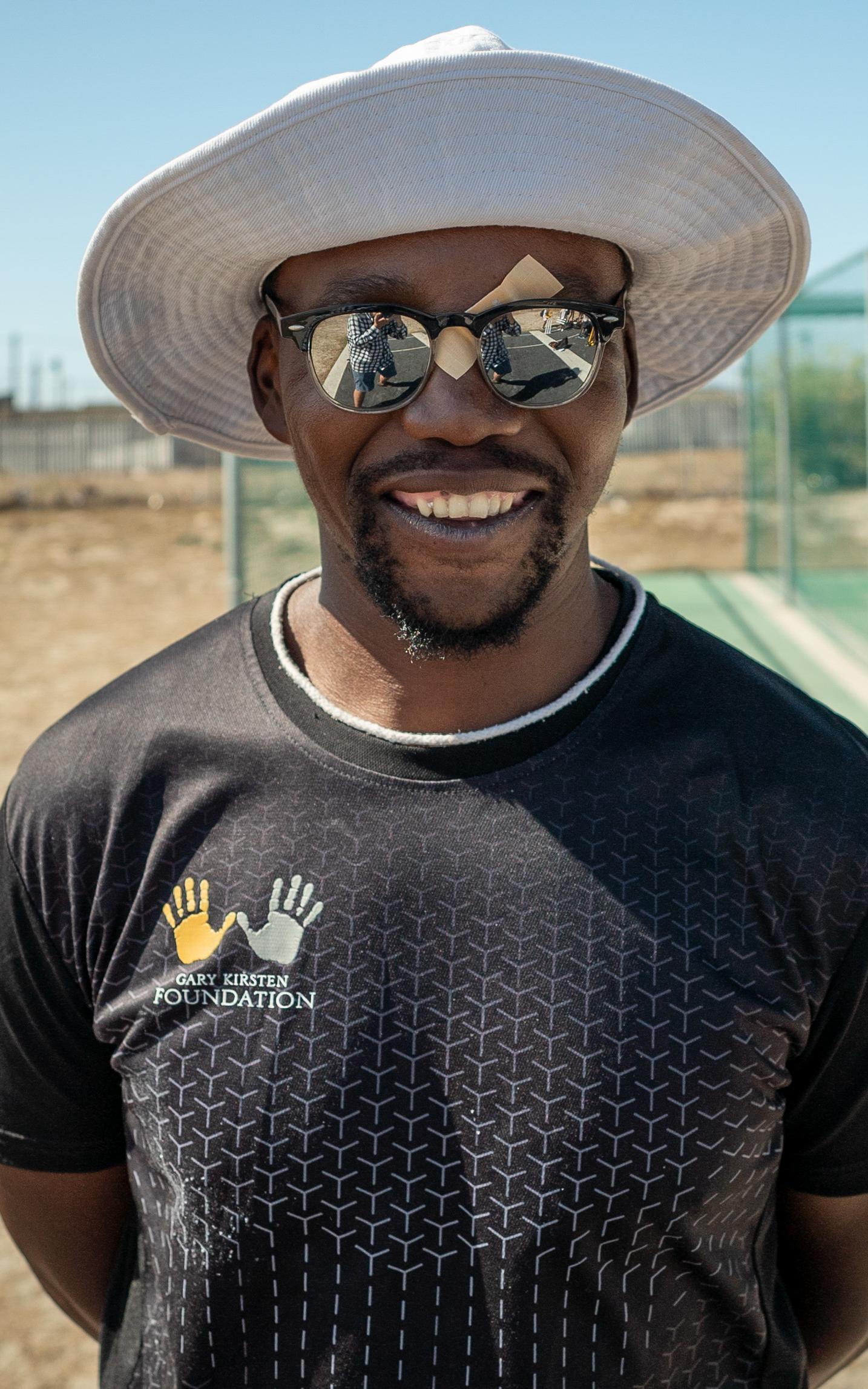Man by cricket nets. 
