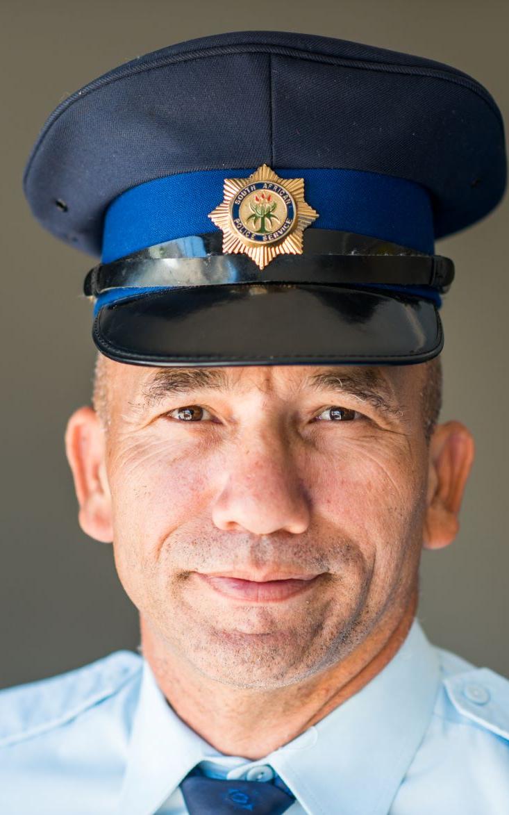 Officer smiling into camera.