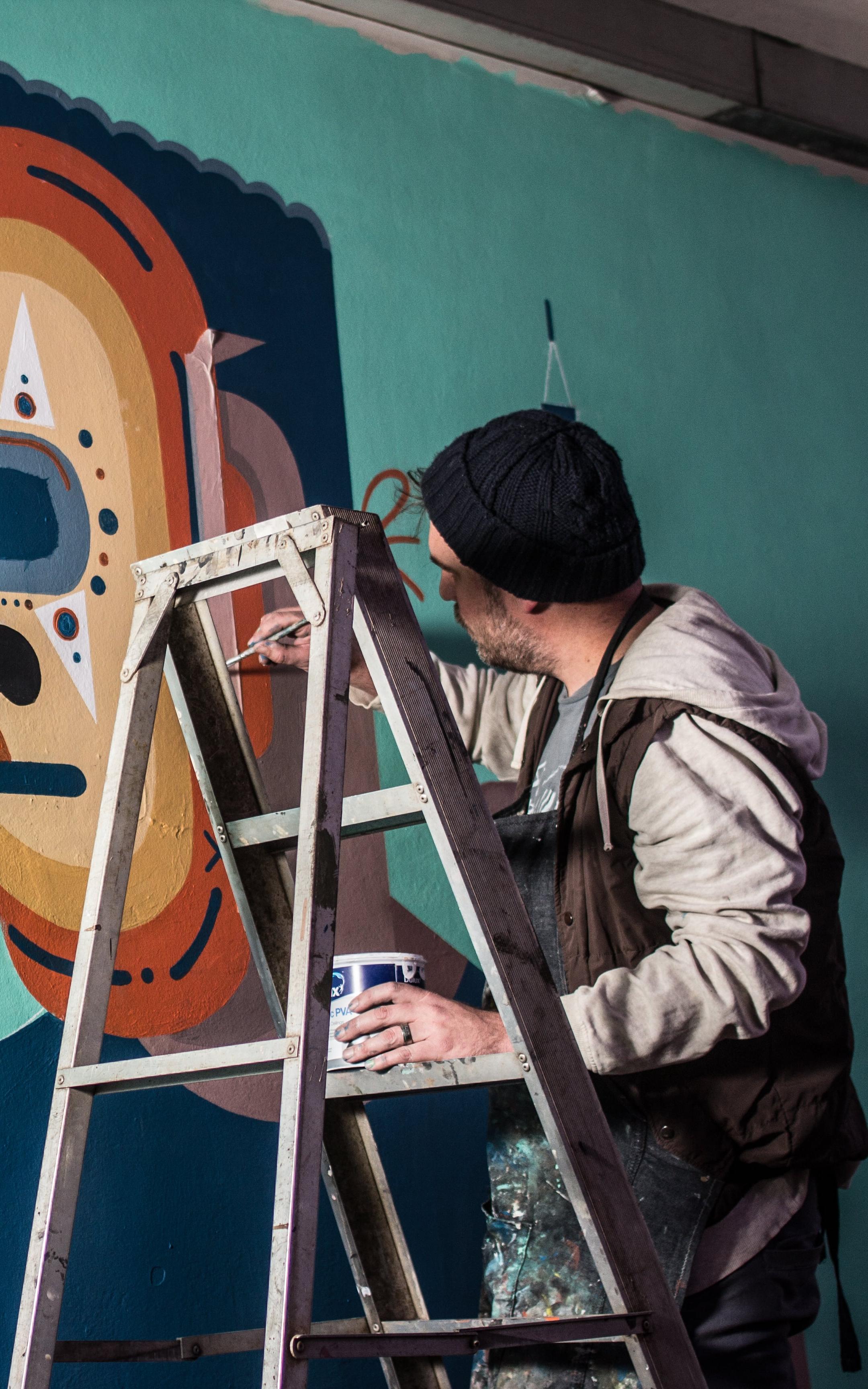 Graffiti artist painting on a wall