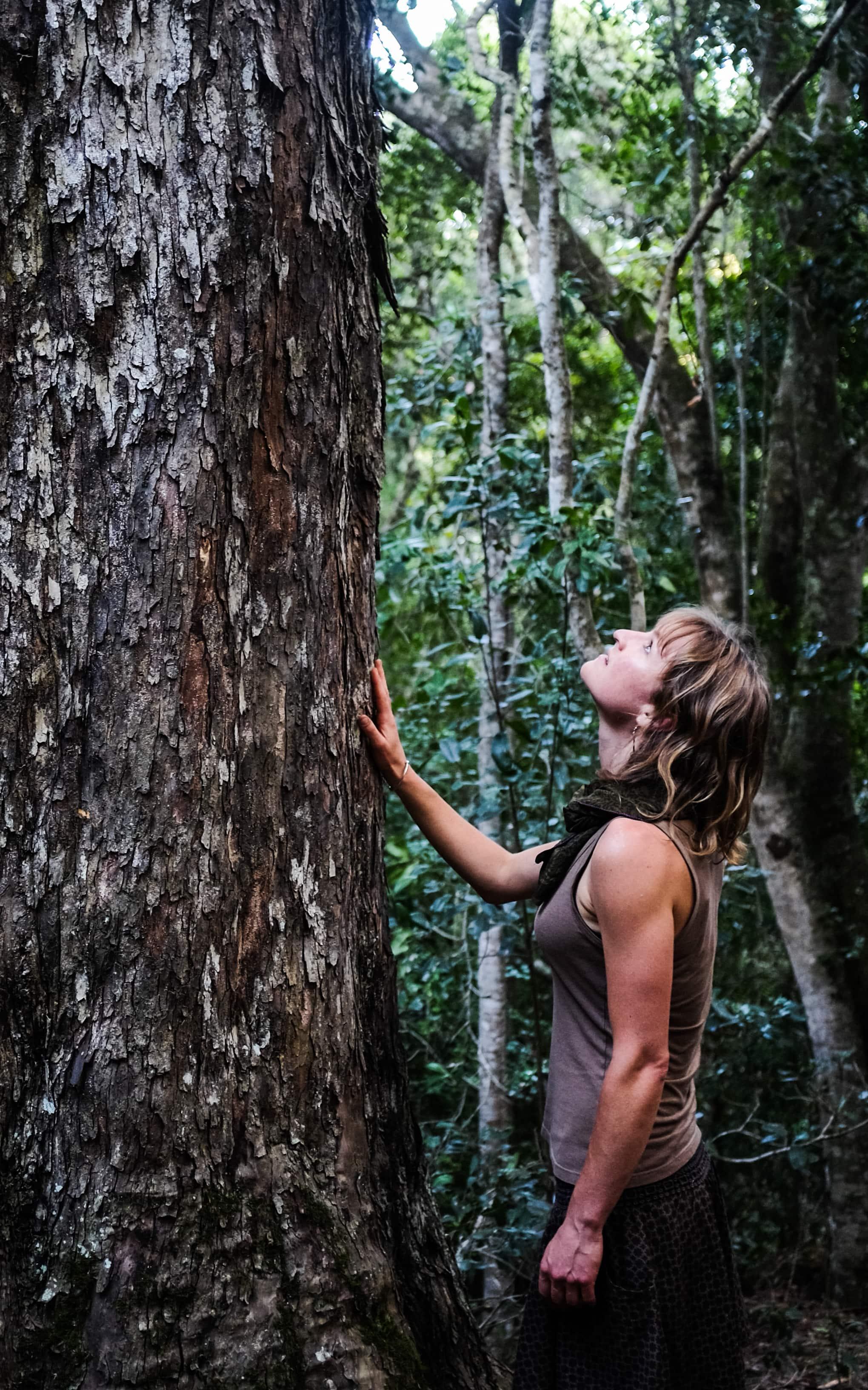 Woman standing next to a tree