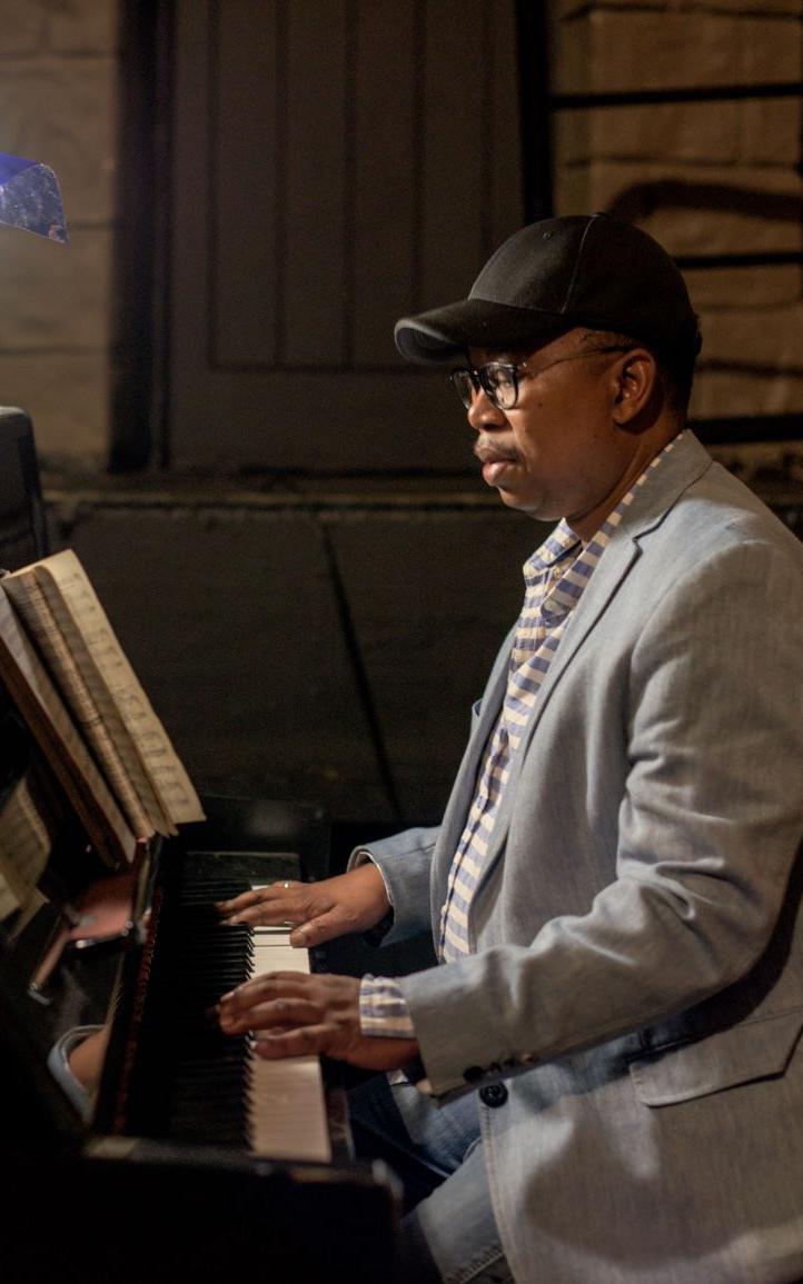 Black musician playing the piano.