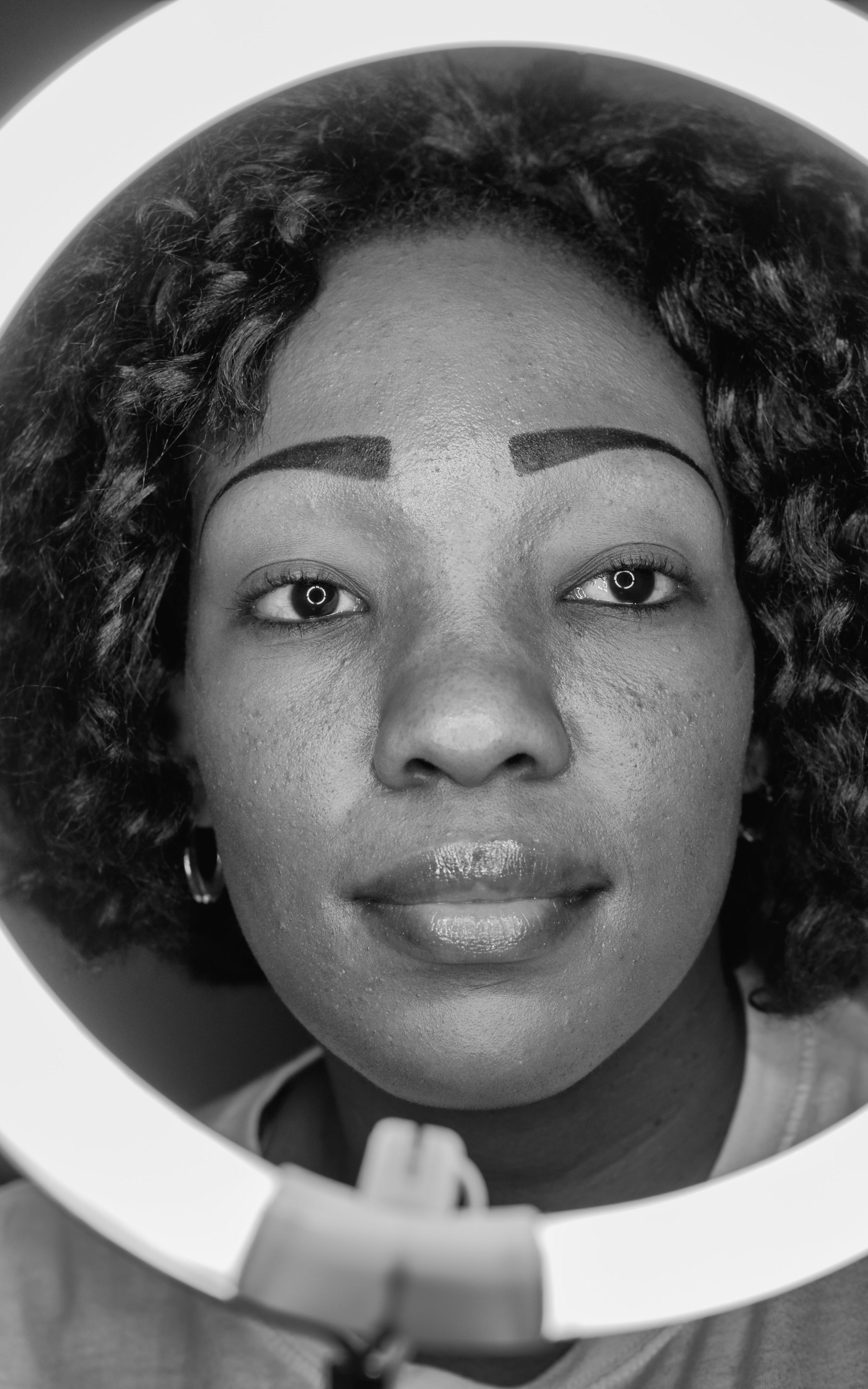 Woman smiling behing ring light