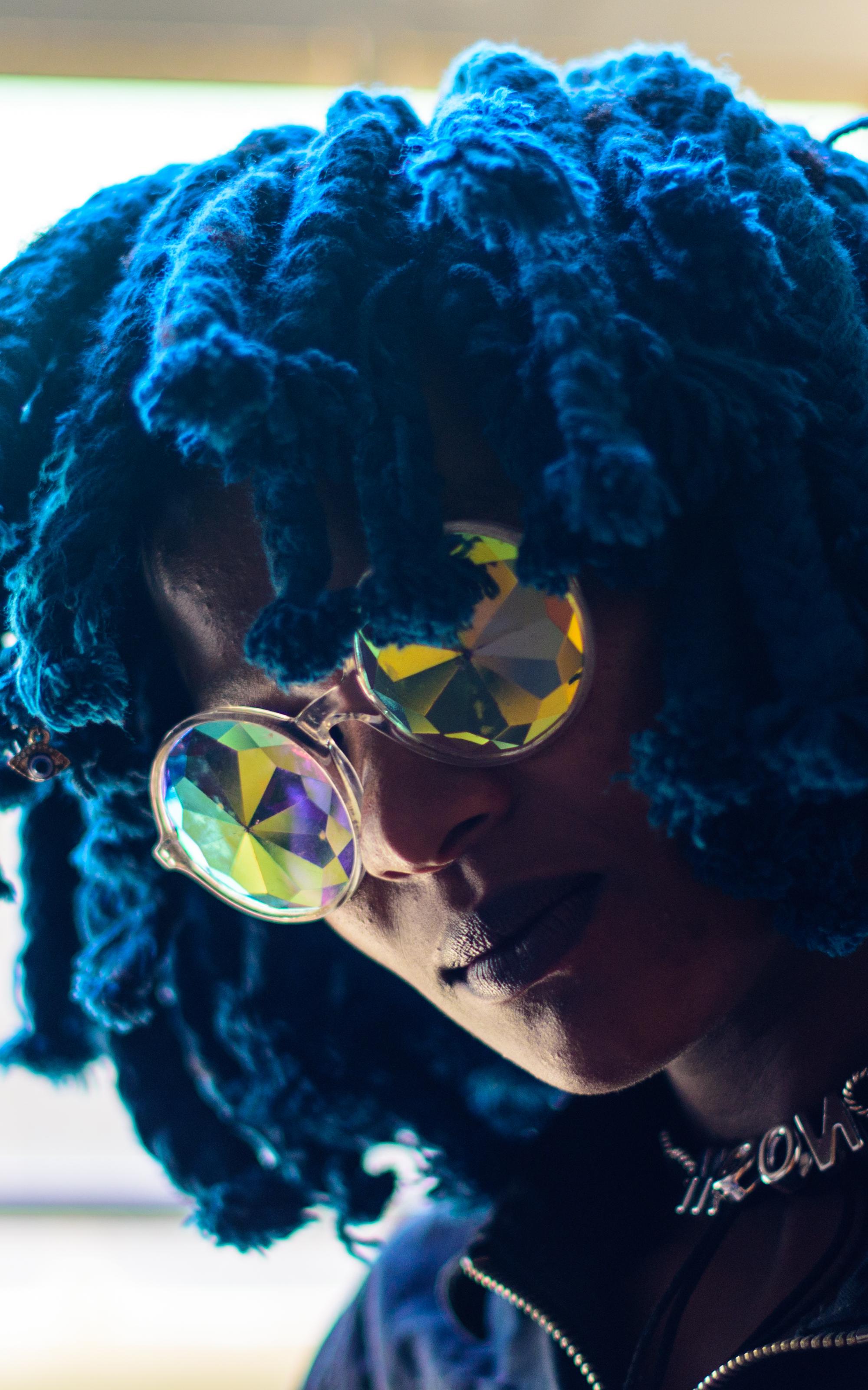 Woman with blue hair and sunglasses