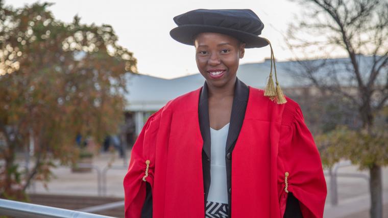 Woman in graduation gear.