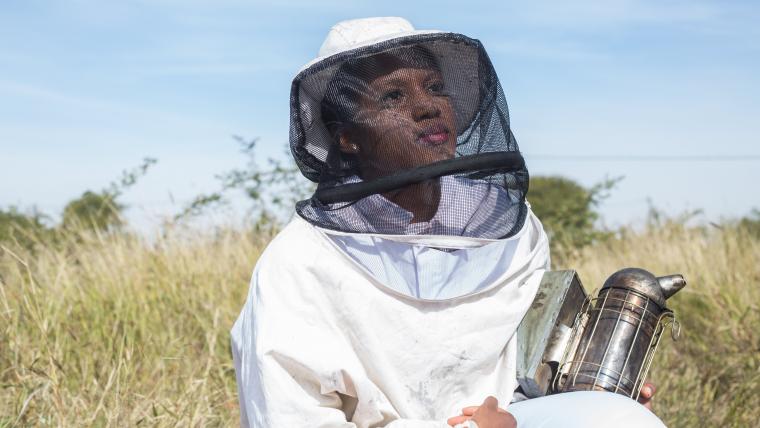 Woman wearing a beekeeping outfit