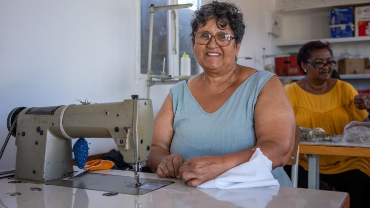 Beautiful News-Woman smiling with sewing machine. 