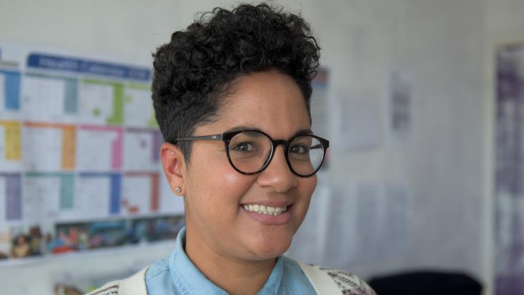 Lady wearing glasses, smiling at camera