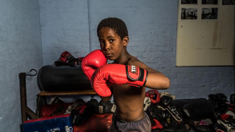Black boy with boxing gloves.