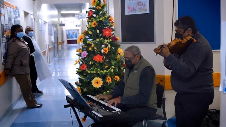 Beautiful News-Men playing music in a hospital.