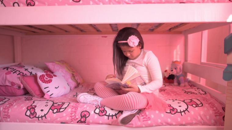 Girl sitting on bed