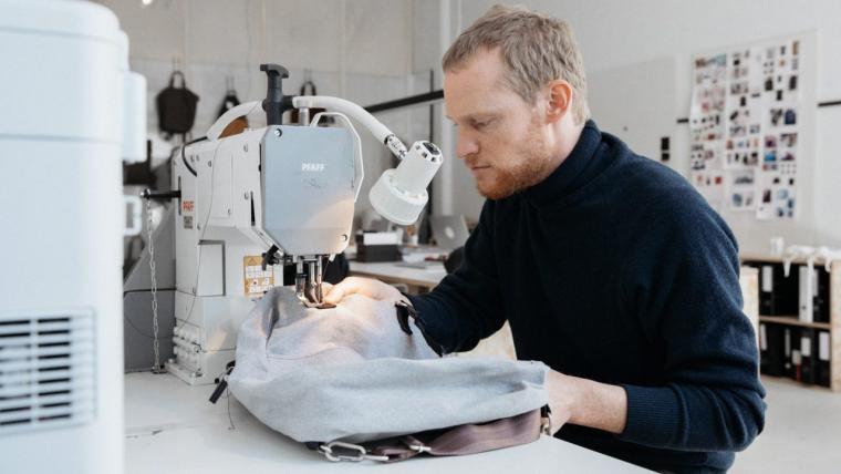 Beautiful News-Man with sewing machine.