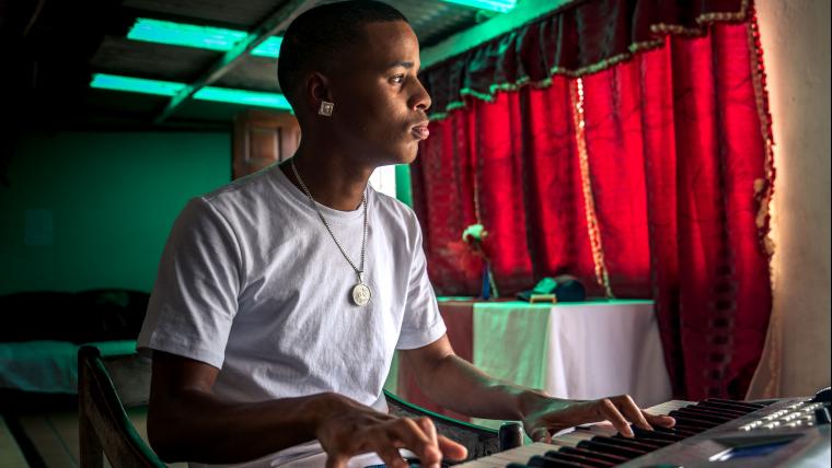 A young man playing the piano
