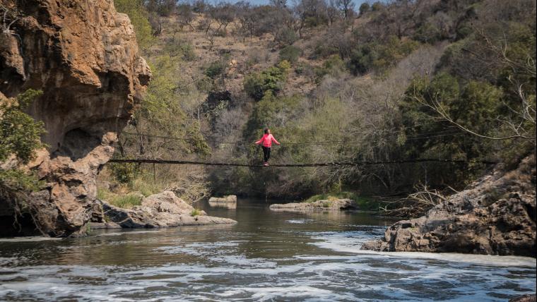 Woman standing on a bridge over water