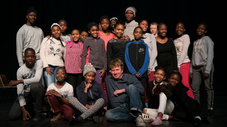 Man posing with group of children