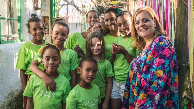 Woman and group of girls smiling to camera