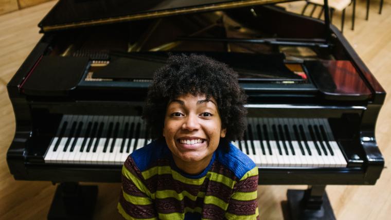 girl smiling by piano