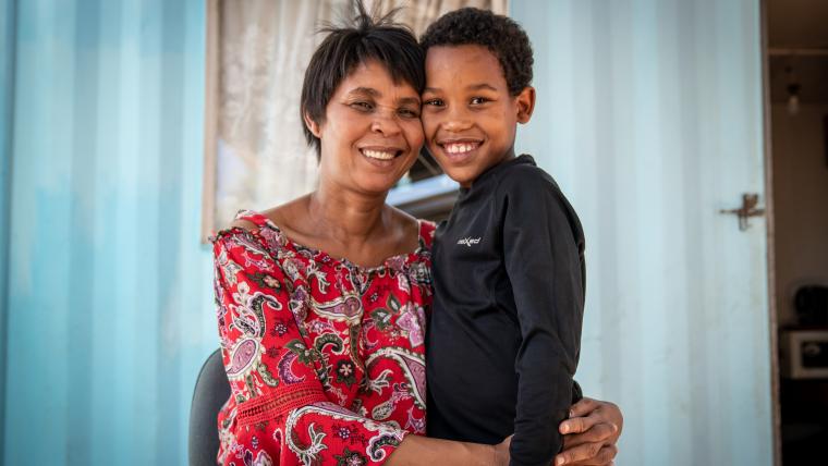 Woman hugging child. 