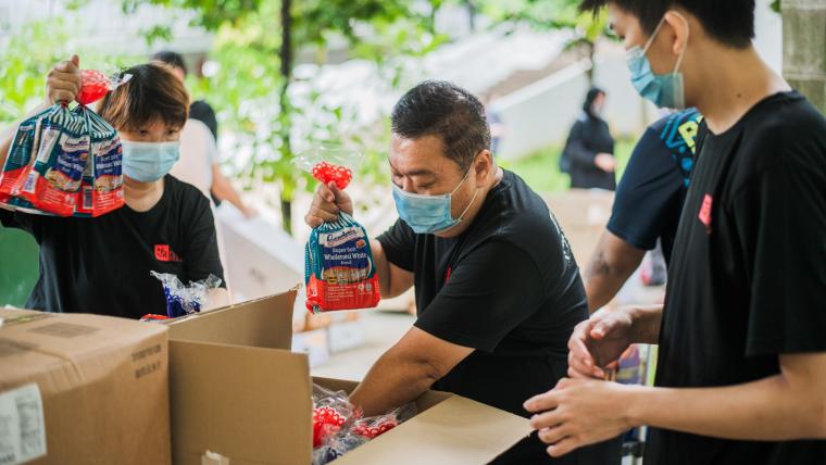 Men packing food.