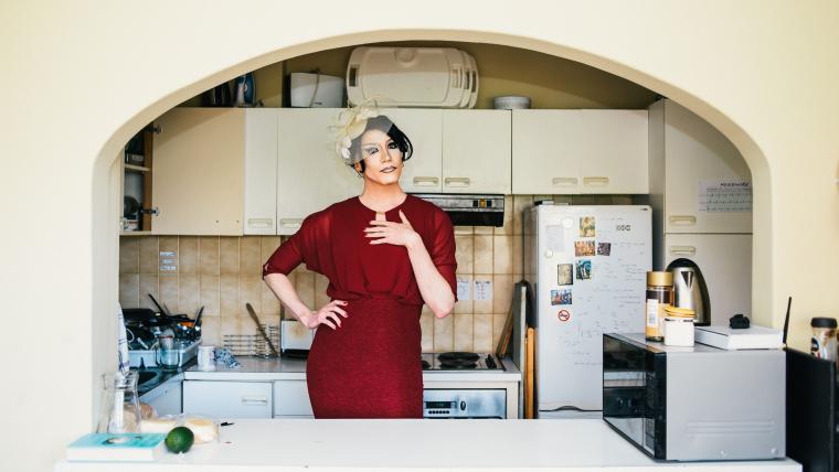 Man in drag standing in a kitchen