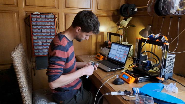 Man making a ventilator.