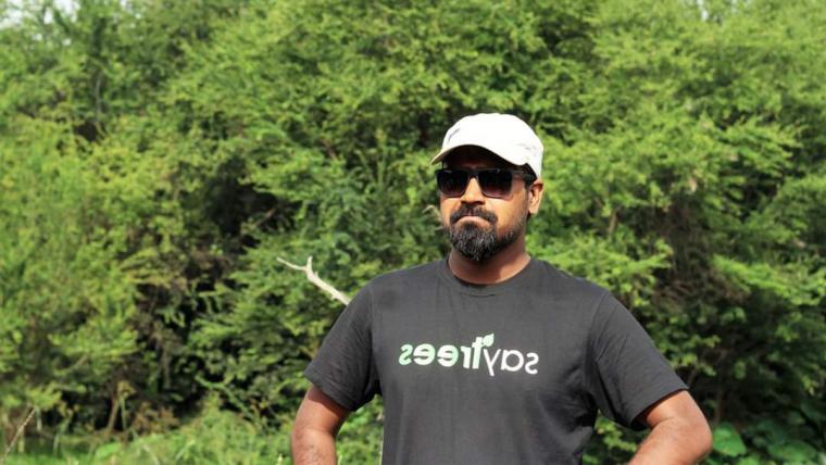 Beautiful News- Man standing in front of trees