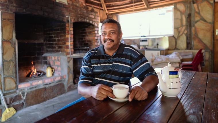 Beautiful News-Man witting with a cup of tea.