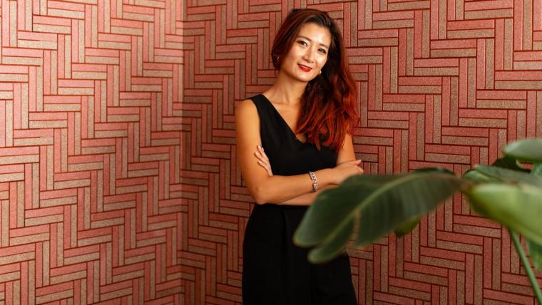 Beautiful News-Woman standing in front of tiled wall