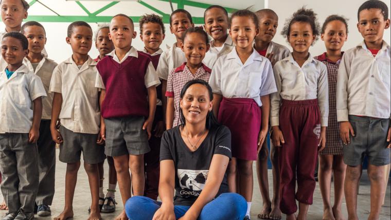 Woman smiling with school children