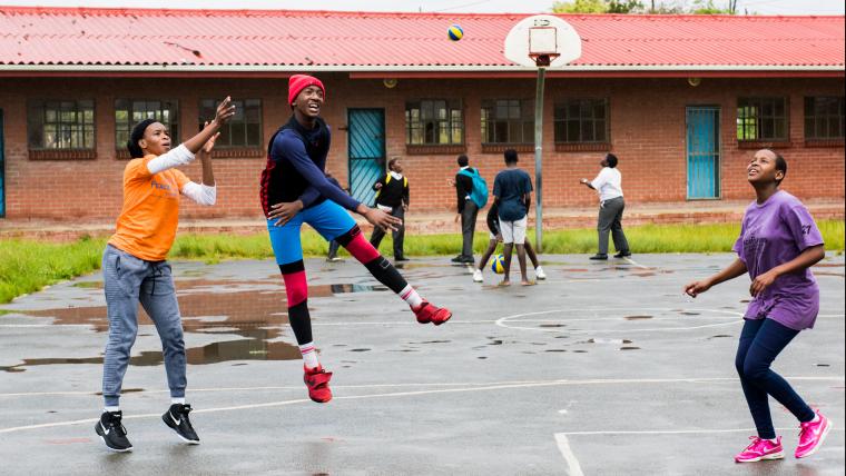 Teens playing basketball