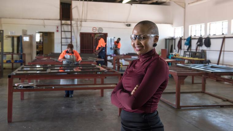 Black woman smiling and wearing protective glasses