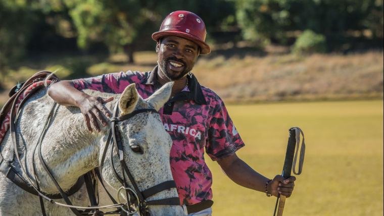 Horse rider next to a horse.