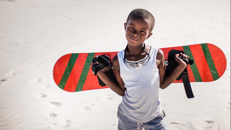 Black boy posing with sandboard