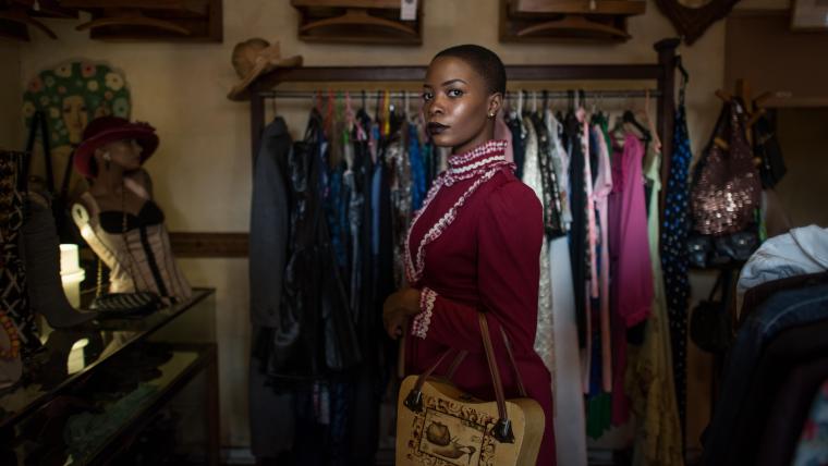 Woman standing in clothing store