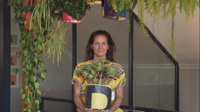 woman holding a plant