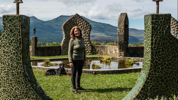 Woman stands in the middle of an ecological shrine