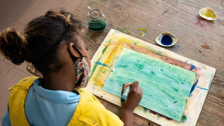 Beautiful News-Masked child painting.