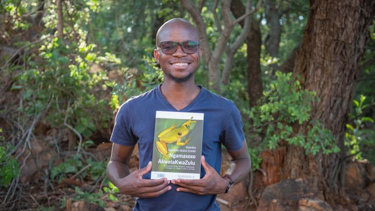 Black man holding a book