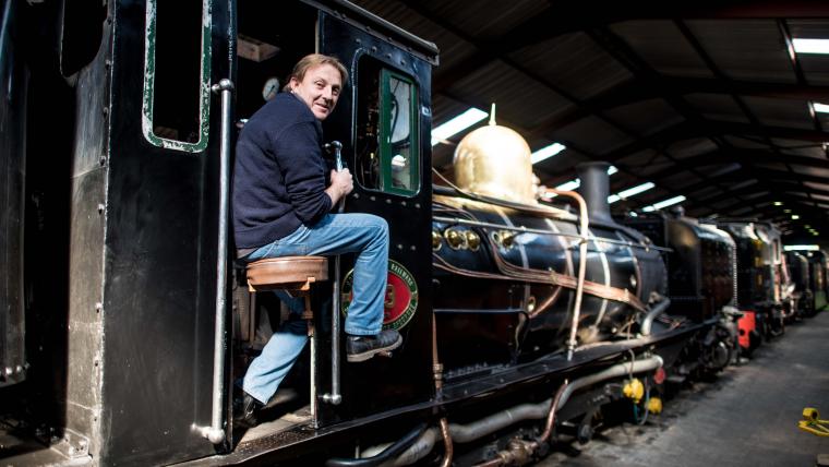 Caucasian man smiling on train