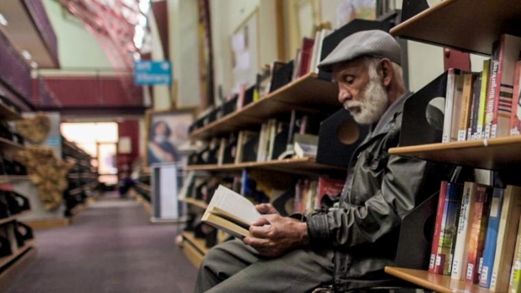 Man reading in library.