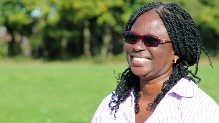 Beautiful News-Woman in dark shades smiling.