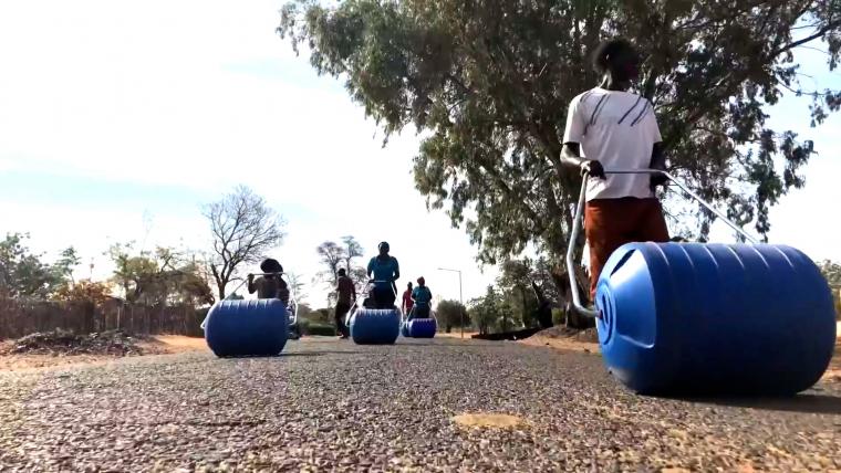 Beautiful News- People rolling water buckets
