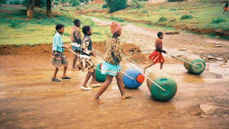 Beautiful News-Children rolling water barrels