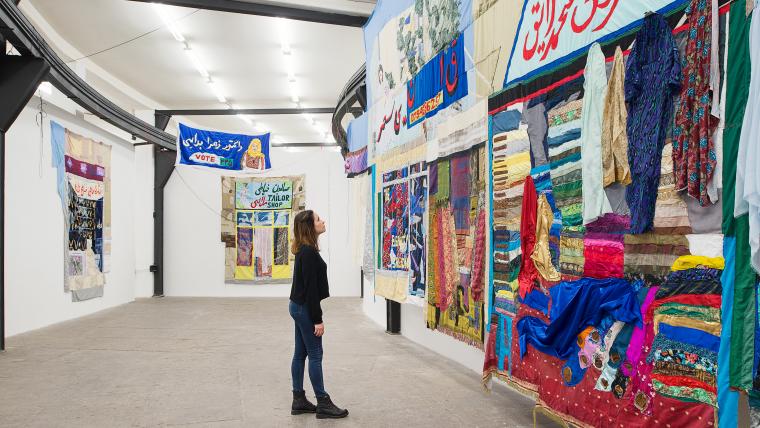 Beautiful News- Woman admires textiles display