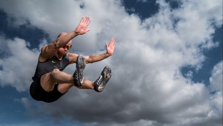 Blind long jumper in the air.