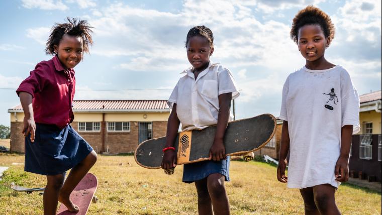 3 female children with skateboards