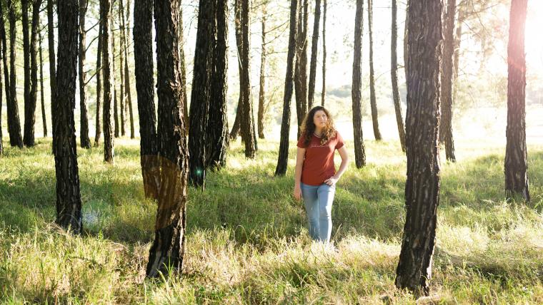Beautiful News - Teen Poet Jess Robus standing in forest with tall green grass