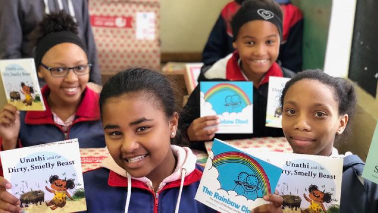 Beautiful News - Children of Book Dash holding up their books and smiling