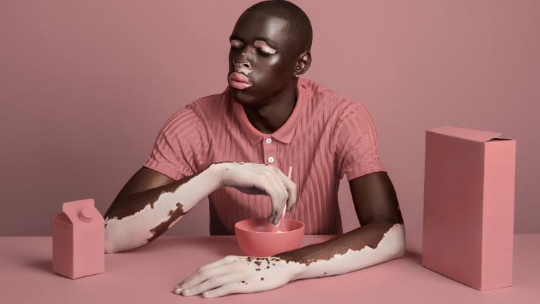 Man at a pink table