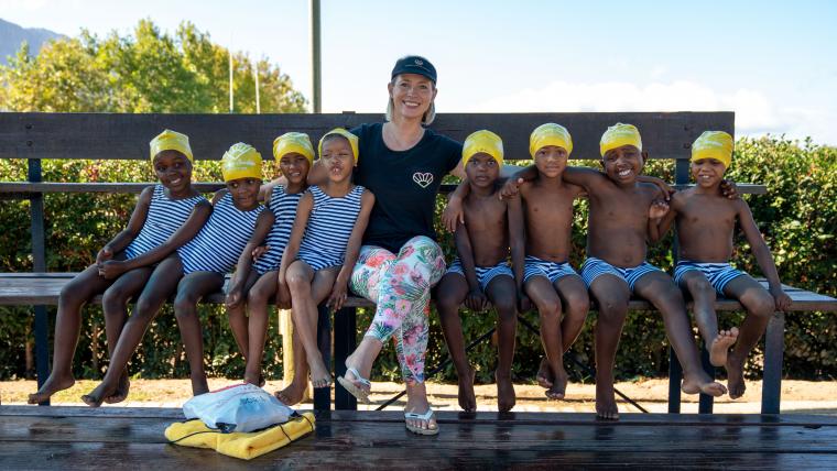 Beautiful News-Woman with her swimming students.